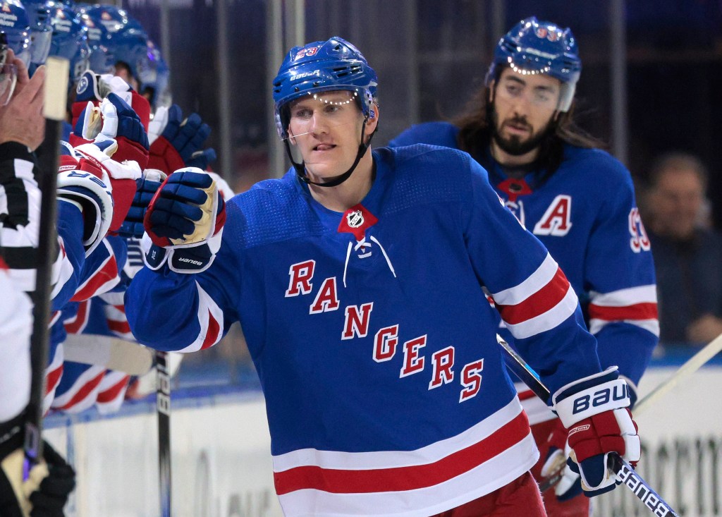 Adam Fox celebrates with teammates after scoring a goal during a regular-season game. The Rangers' defenseman missed practice again for a "maintenance day."