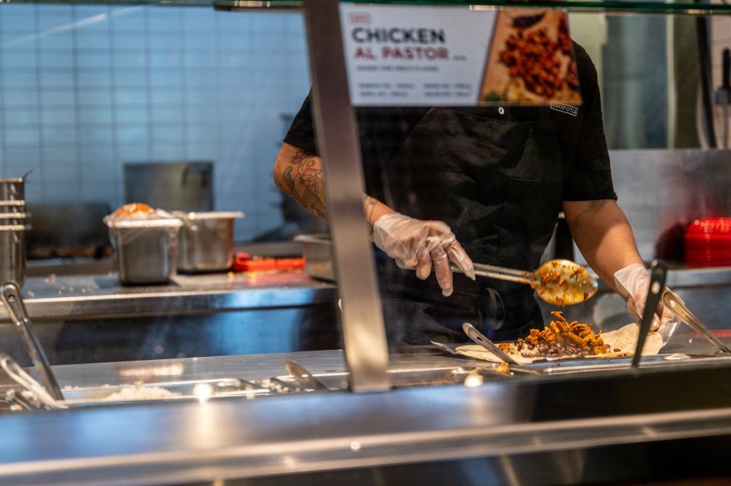 AUSTIN, TEXAS - APRIL 26: An employee prepares food at a Chipotle Mexican Grill restaurant on April 26, 2023 in Austin, Texas. Chipotle Mexican Grill posted strong quarterly earnings. Chipotle shares climbed as same-store sales rose 10.9%.