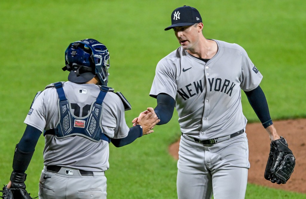 Clay Holmes celebrates with Jose Trevino after picking up his 10th save of the season in the Yankees' 2-0 win over the Orioles.