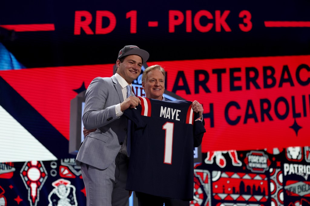 Drake Maye poses with NFL Commissioner Roger Goodell after being selected third overall by the New England Patriots during the first round of the 2024 NFL Draft at Campus Martius Park and Hart Plaza on April 25, 2024 in Detroit, Michigan. 