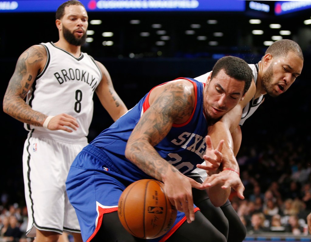 Brooklyn Nets  guard Deron Williams (8), left, watches as Nets center Jerome Jordan, right, strips the ball from Philadelphia 76ers forward Drew Gordon (30) in the first half of an NBA basketball game at the Barclays Center, Monday, Oct. 20, 2014, in New York.