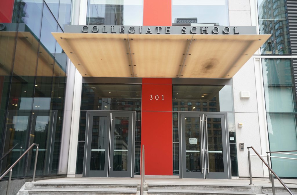 Exterior view of Collegiate School with glass doors and a red sign, located at 301 Freedom Place, Manhattan