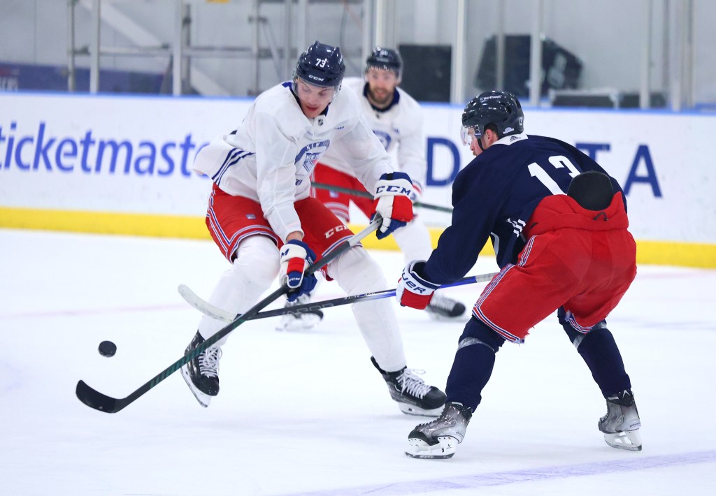 Matt Rempe (left) looks to regain control of the puck during the Rangers' practice on Wednesday.