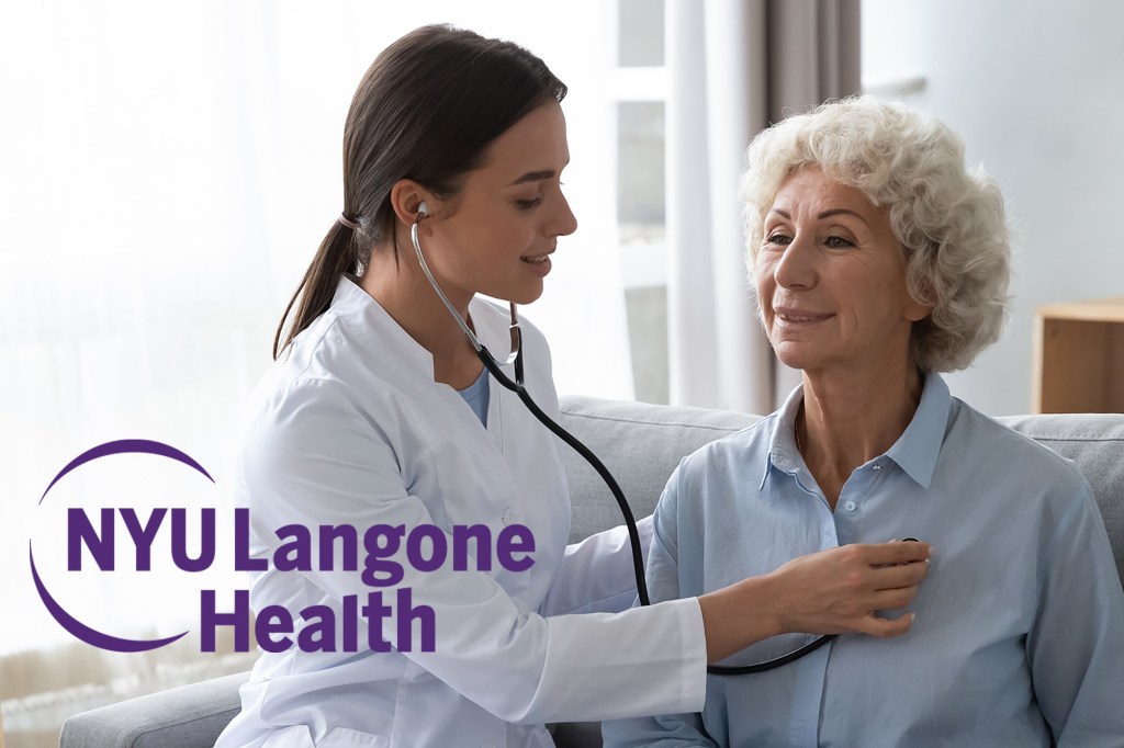 Doctor listening to an older woman's heart.