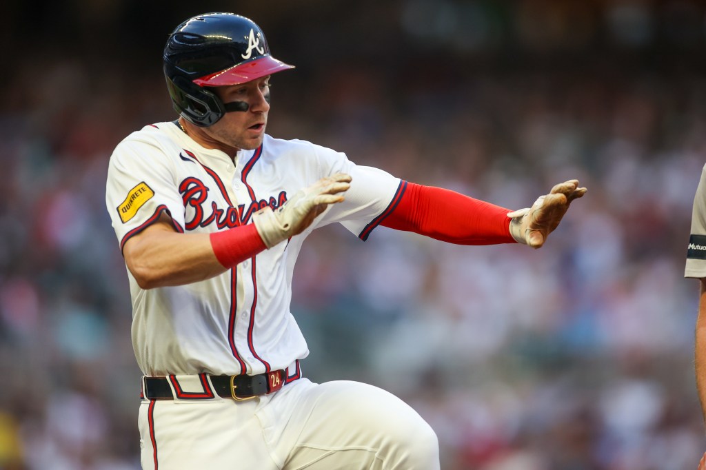 Atlanta Braves left fielder Jarred Kelenic (24) attempts to avoid a player against the Boston Red Sox