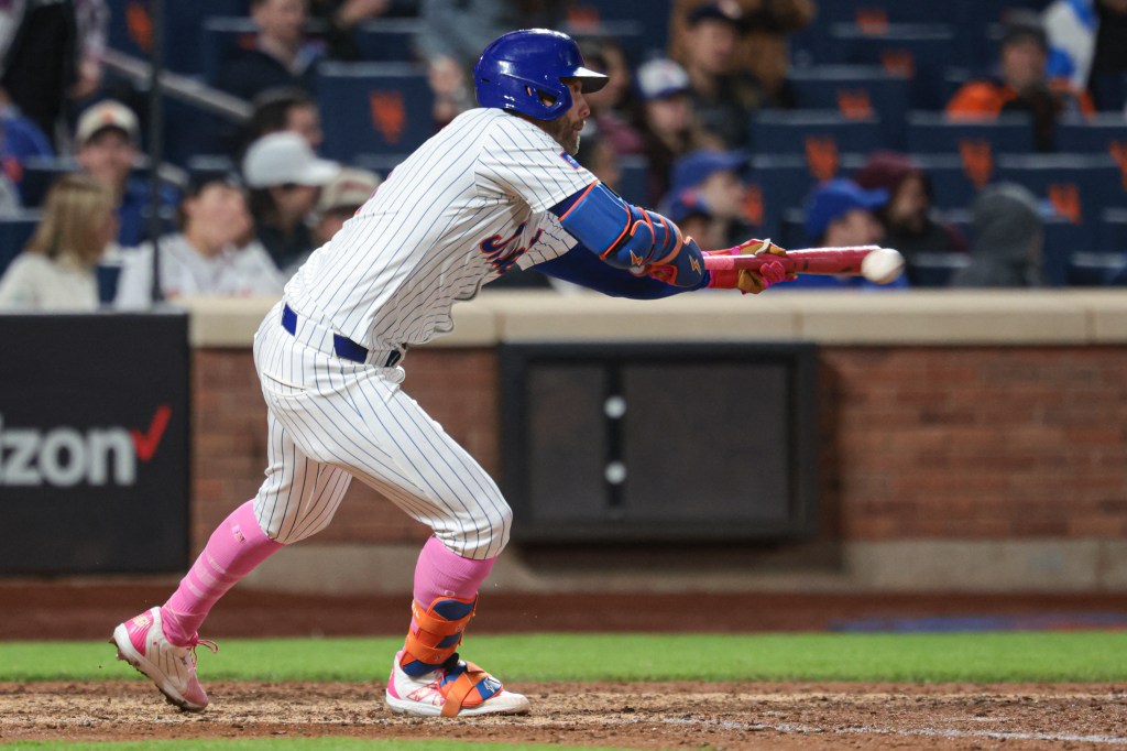 Jeff McNeil bunts for a hit during the ninth inning of the Mets' win over the Braves on May 12, 2024. 