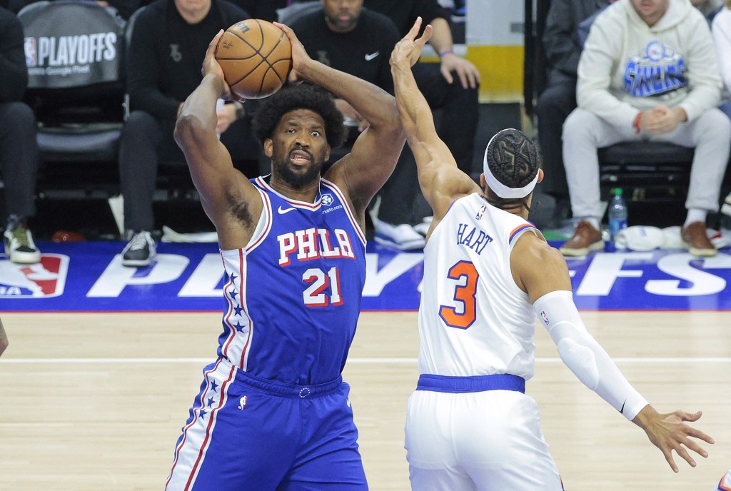 Joel Embiid, who scored 39 points, looks to make a pass around Josh Hart during the Knicks' 118-115 series-clinching win over the 76ers in Game 6.