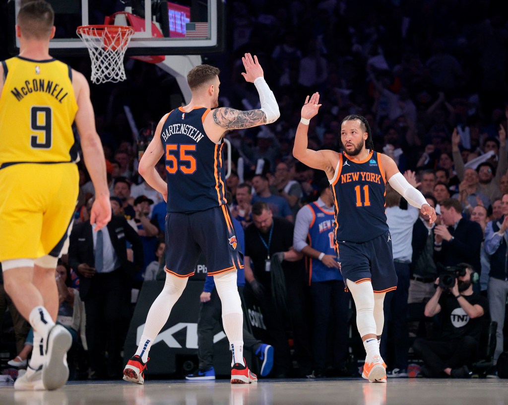 New York Knicks center Isaiah Hartenstein #55 greets New York Knicks guard Jalen Brunson #11 after scoring during the first quarter.
