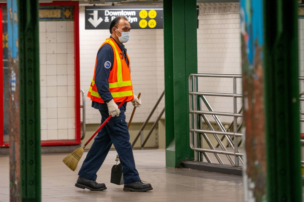 An MTA employee wearing a mask and gloves sweeps in the Union Square subway station amid the coronavirus pandemic on May 6, 2020 in New York City.