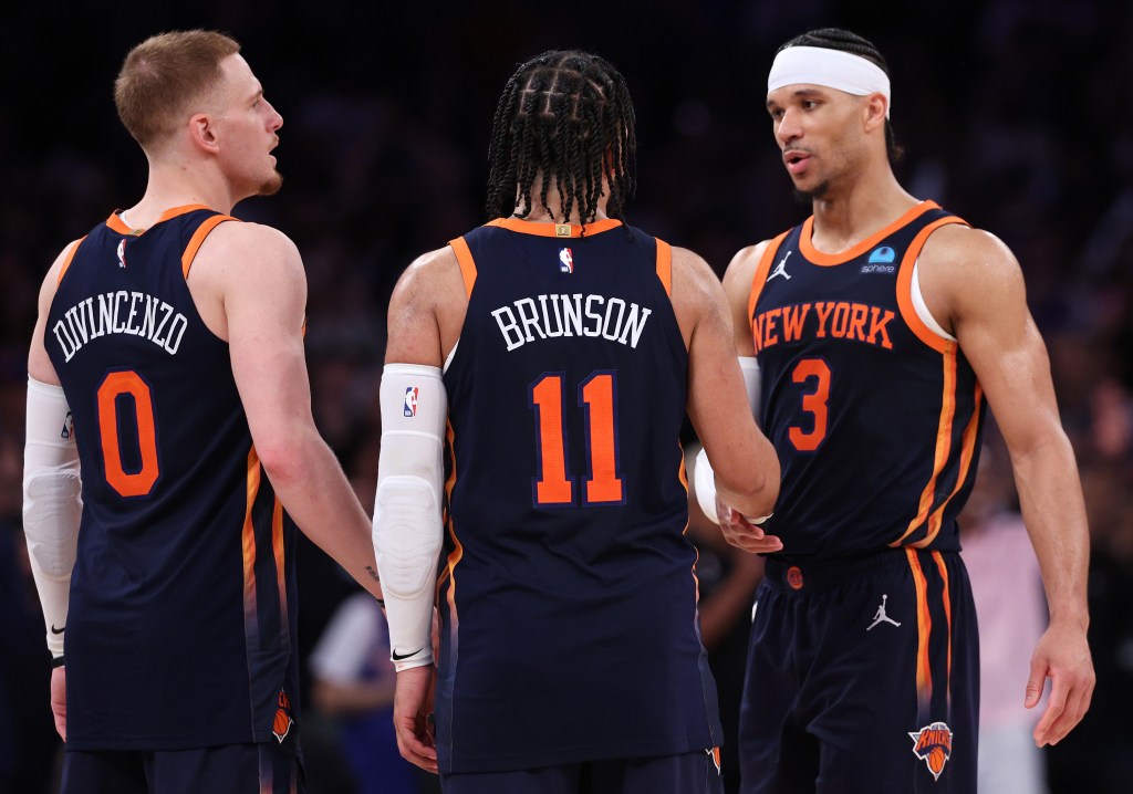 Donte DiVincenzo #0, Jalen Brunson #11 and Josh Hart #3 of the New York Knicks celebrate their win against the Indiana Pacers in Game Two of the Eastern Conference Second Round Playoffs at Madison Square Garden on May 08, 2024 in New York City. 