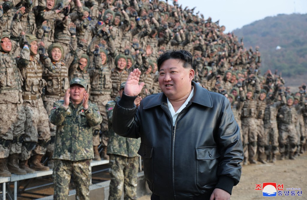 North Korean dictator Kim Jong Un waving in front of military troops