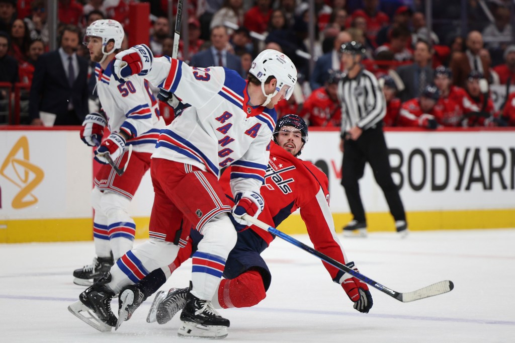 Adam Fox collides with Hendrix Lapierre during Game 3 of the Rangers' sweep of the Capitals.