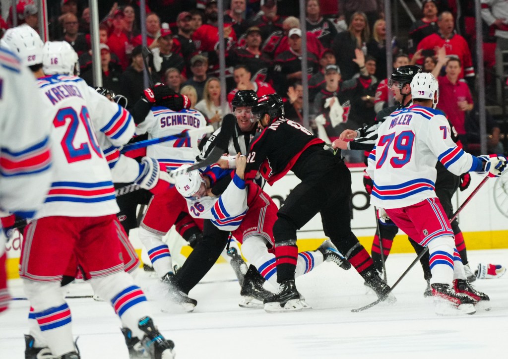 Hurricanes center Jesperi Kotkaniemi (82) and New York Rangers left wing Jimmy Vesey (26) battle during the first period