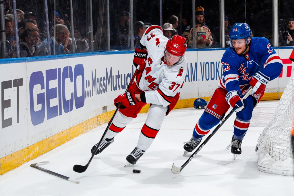 Adam Fox (R.) battles for the puck during the Rangers' Game 1 win over the Hurricanes on May 5,, 2024. 