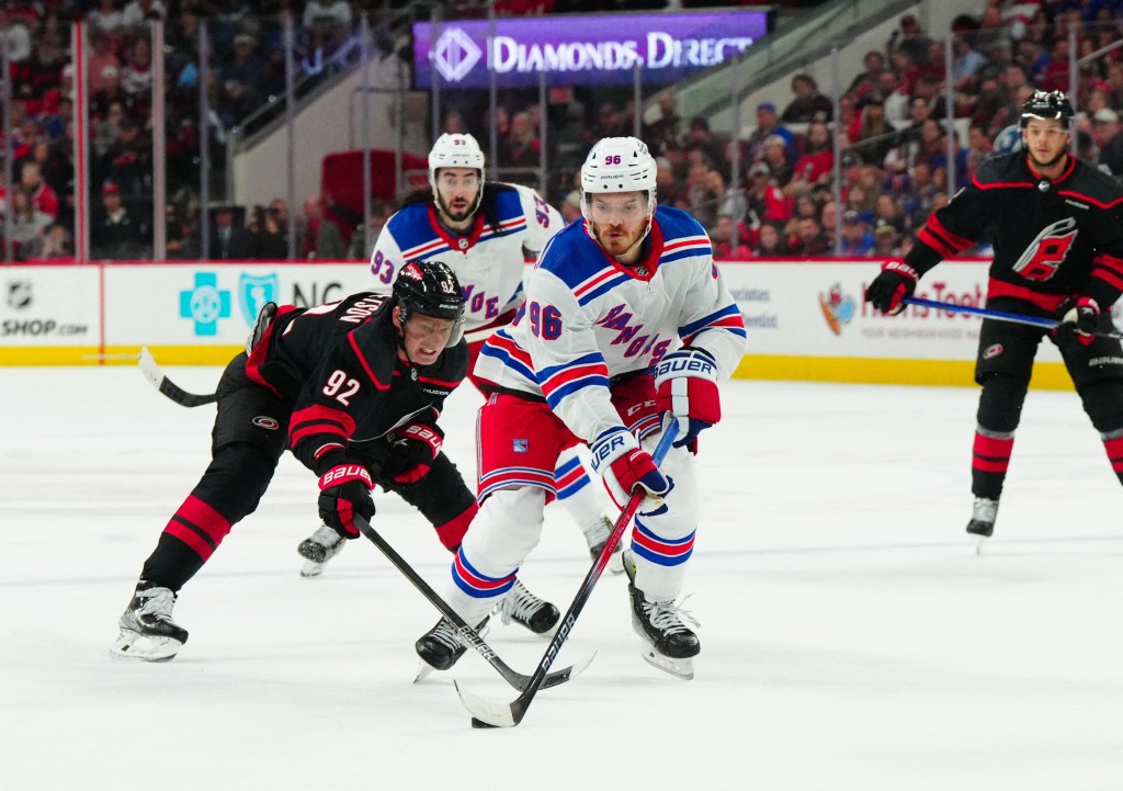 Rangers center Jack Roslovic (96) skates with the puck past Carolina Hurricanes center Evgeny Kuznetsov