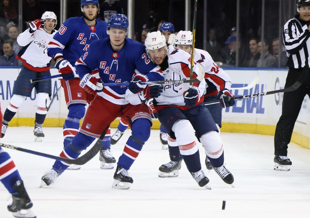 Kaapo Kakko battles with the puck with T.J. Oshie during the Rangers' Game 2 win over the Capitals on April 23, 2024. 