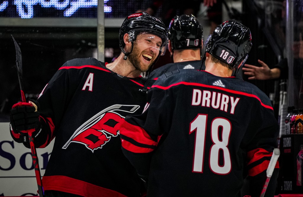 Jaccob Slavin celebrates with Jack Drury after the Hurricanes eliminated the Islanders, thanks to a 6-3 Game 5 victory.