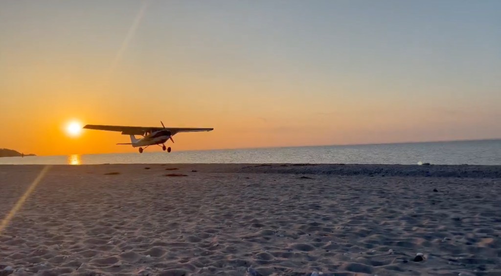 Small plane making an emergency landing on Cedar Beach with pilot and passenger safe