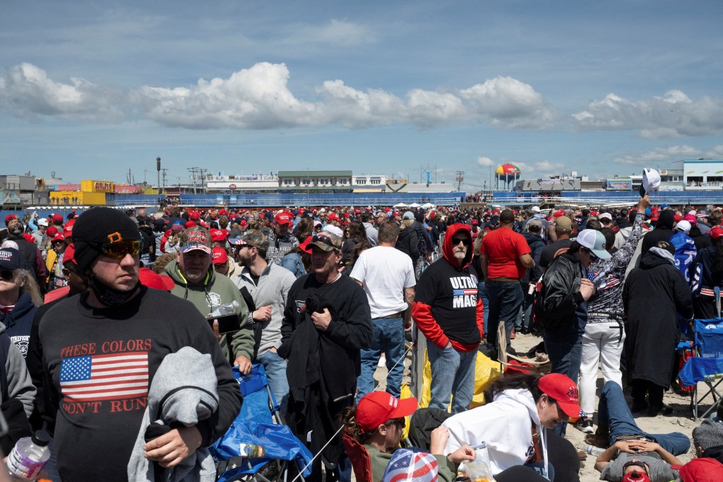 A large crowd of supporters in red hats waiting to attend a Donald Trump campaign rally in Wildwood, New Jersey on May 11, 2024.