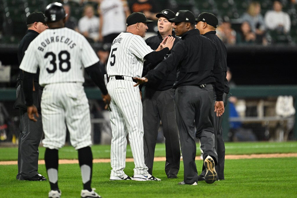 Manager Pedro Grifol #5 of the Chicago White Sox talks with umpires after baserunner Andrew Vaughn #25 was called out for interference ending the game against the Baltimore Orioles at Guaranteed Rate Field on May 23, 2024 in Chicago, Illinois. 