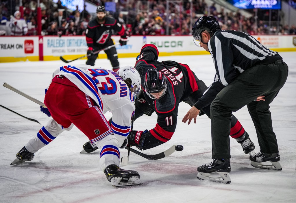 Rangers forward Mika Zibanejad battles the Hurricanes' Jordan Staal on a face off during a regular season matchup between the two teams.