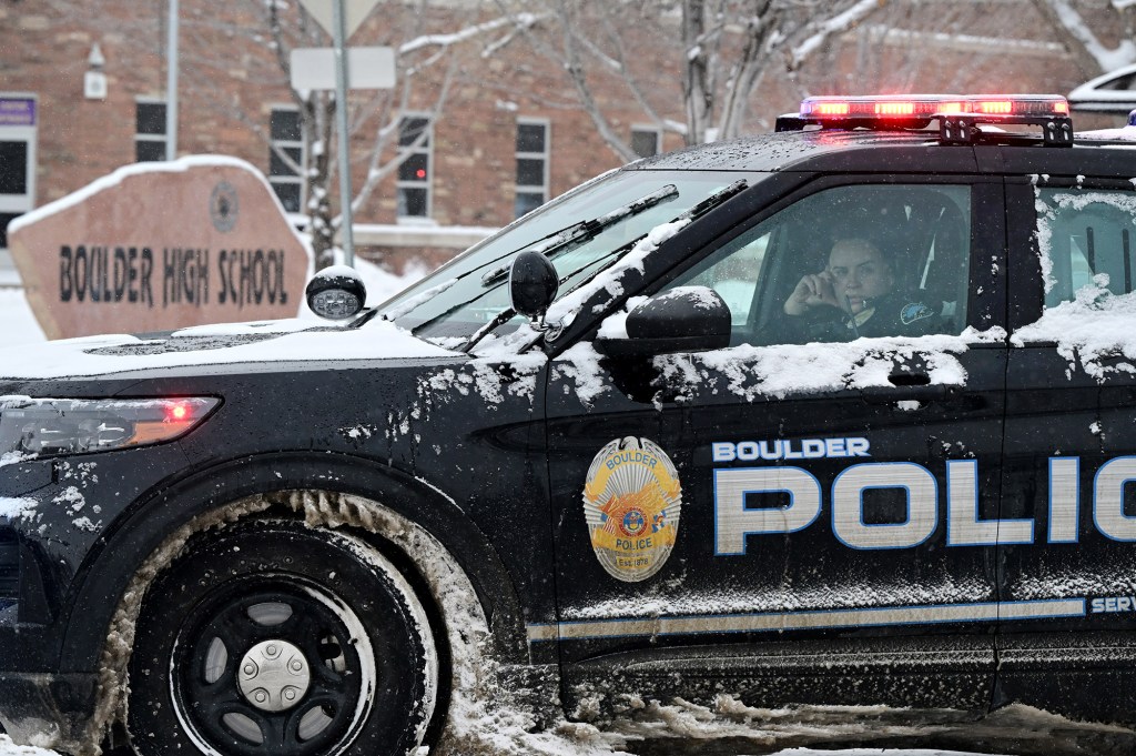  A Boulder police officer sits in her cruiser outside of Boulder High School in response to an unconfirmed report of a person with a gun at the school on February 22, 2023 in Boulder, Colorado