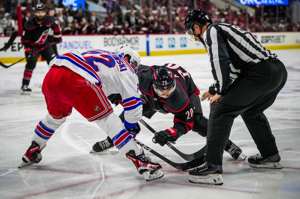 Sebastian Aho #20 of the Carolina Hurricanes faces off against Jonny Brodzinski #22 of the New York Rangers during the first period in Game Six of the Second Round of the 2024 Stanley Cup Playoffs at PNC Arena