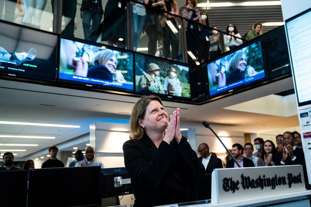 Sally Buzbee, Executive Editor, celebrates in The Washington Post newsroom moments after winning the 2022 Pulitzer Prize for Public Service for coverage of the January 6, 2021.