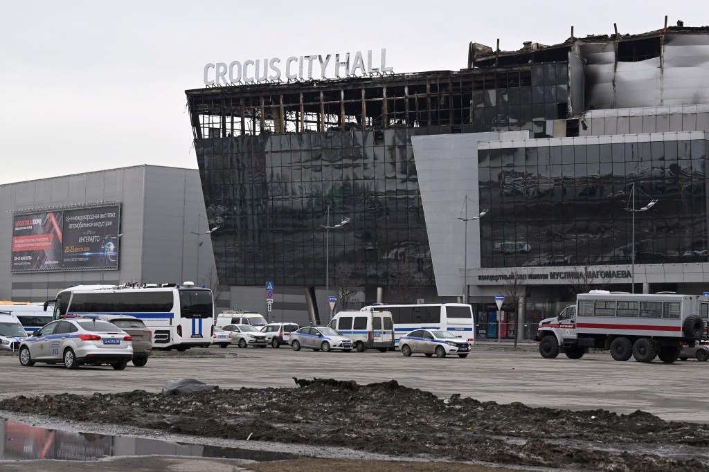 Police cars are parked outside of the Crocus City Hall in Moscow's northern suburb of Krasnogorsk on March 29, 2024, a week after a deadly attack by gunmen on the Moscow concert hall killed at least 143 people and wounded dozens more