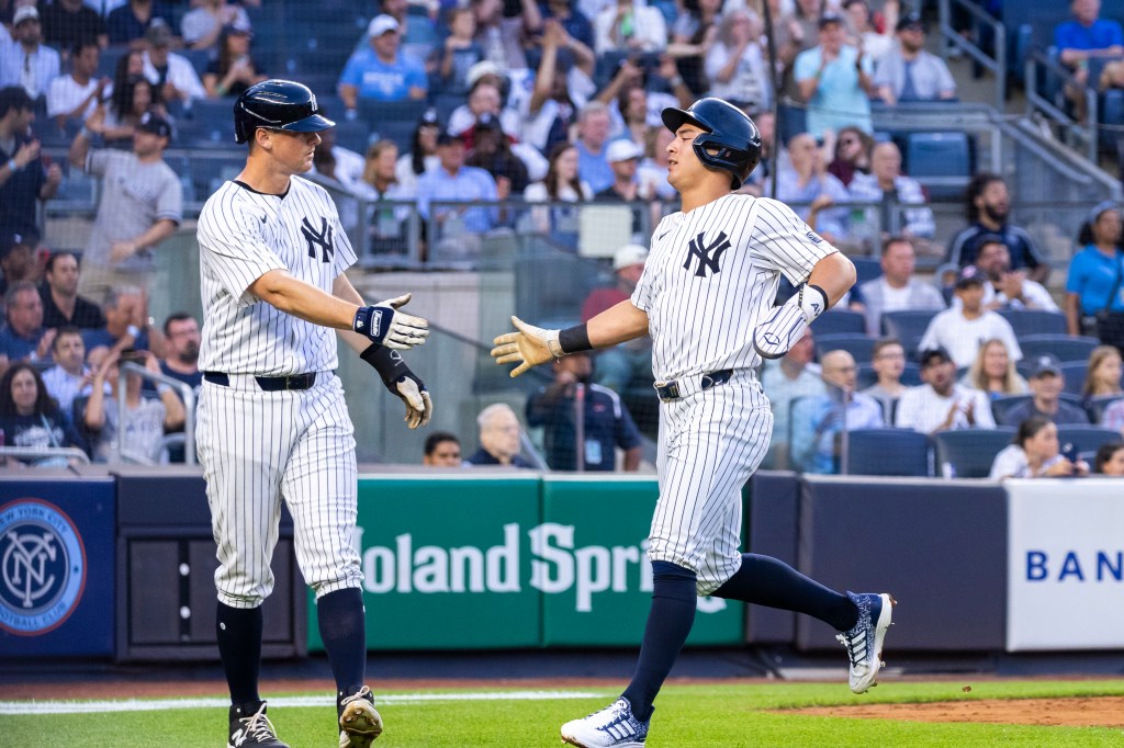 DJ LeMahieu greets Anthony Volpe after both scored on Aaron Judge's two-run double in the third inning of the Yankees' win.