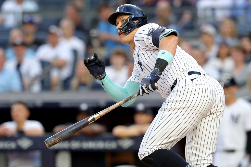 New York Yankees right fielder Aaron Judge (99) follows through on a double against the Los Angeles Dodgers during the first inning at Yankee Stadium.