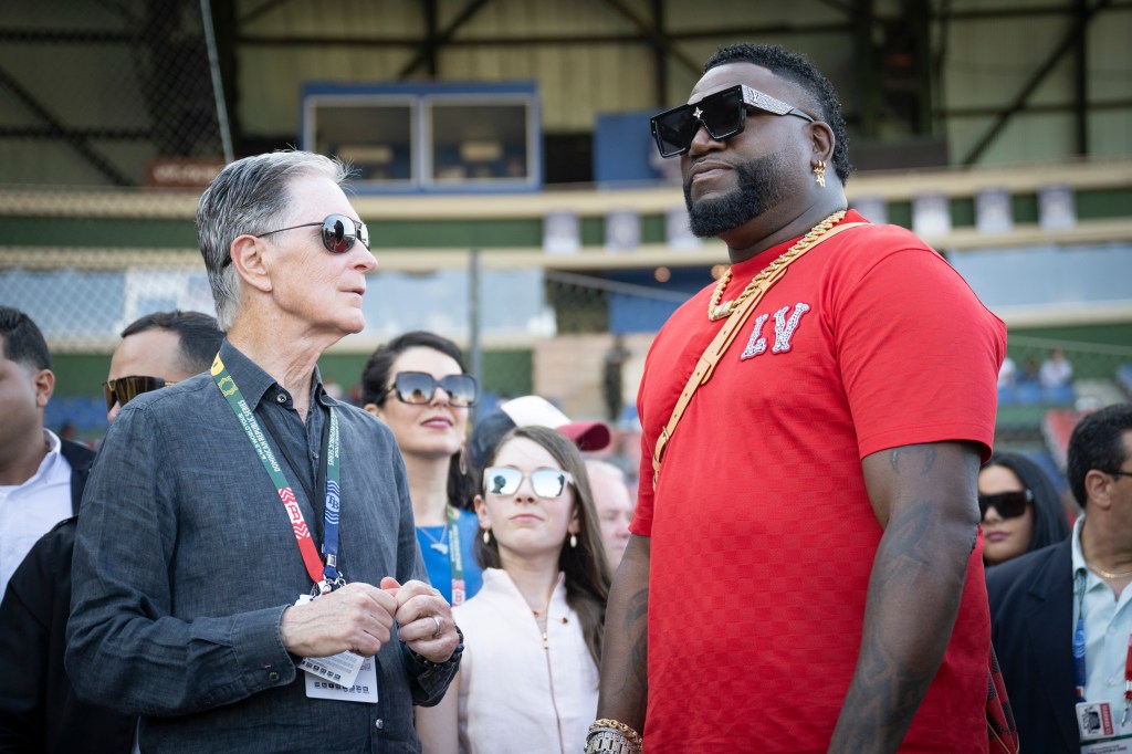 John Henry talks with Former Boston Red Sox designated hitter David Ortiz before the 2024 Dominican Republic Series game against the Tampa Bay Rays on March 9, 2024 in Santo Domingo, Dominican Republic. 