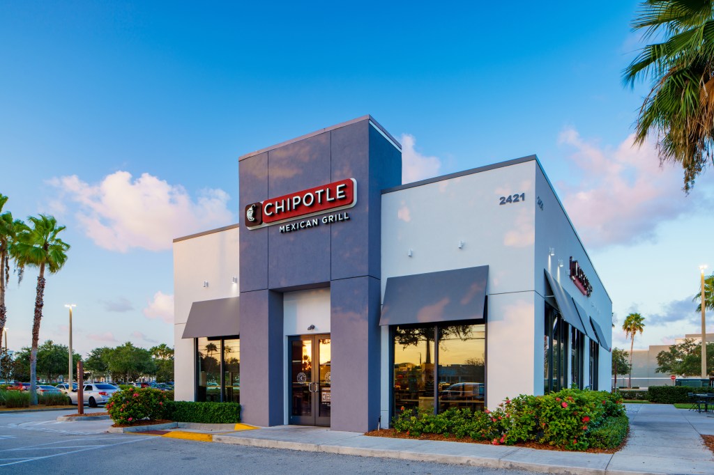 Chipotle Mexican Grill storefront at Pineapple Commons in Stuart, Florida with employees filling customer orders inside