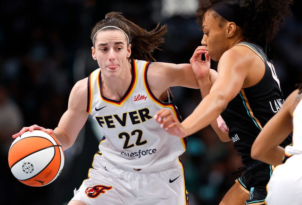 Indiana Fever guard Caitlin Clark (22) drives to the basket against New York Liberty forward Betnijah Laney-Hamilton (44) during the first half of a WNBA basketball game, Saturday, May 18, 2024, in New York. 