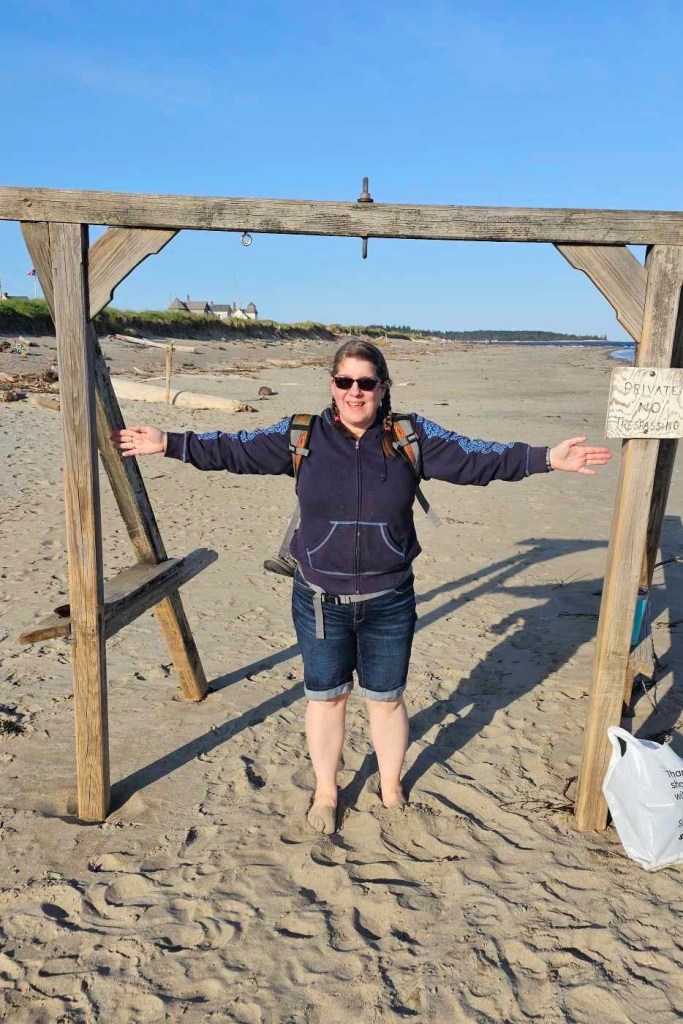 Woman, Jamie Acord, standing with her arms out on Popham Beach -- who sunk to her hips in quicksand