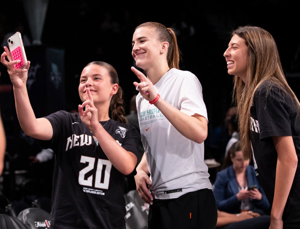 Sabrina Ionescu #20 of the New York Liberty greets fans prior to their game against the Indiana Fever during a Commissioner's Cup matchup at Barclays Center. 
