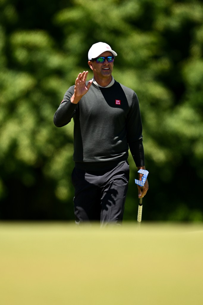 Adam Scott of Australia waves on the second green during the second round of the RBC Canadian Open.