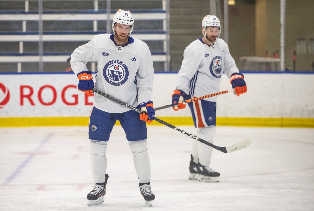 Edmonton Oilers' Connor McDavid (97) and Zach Hyman (18) look on during NHL hockey practice, Wednesday, June 5, 2024, in Edmonton, Alberta.