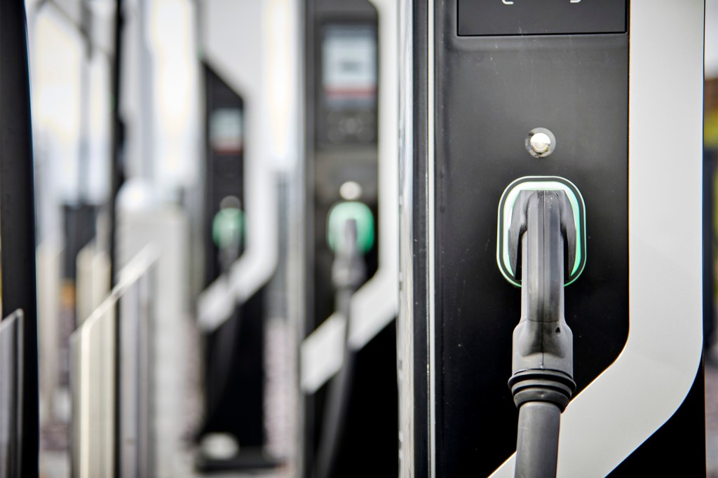 A bank of electric car chargers in black and white