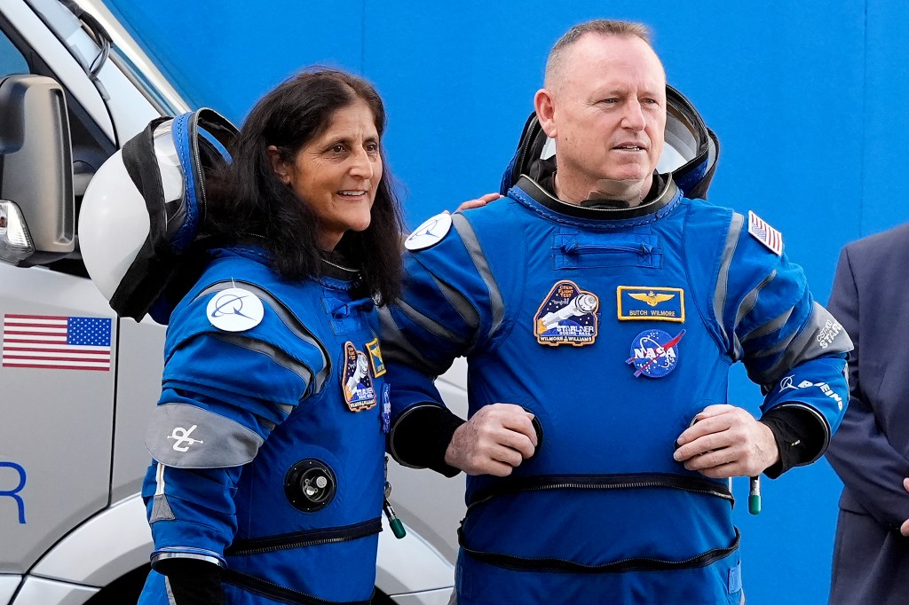 NASA astronauts Suni Williams and Butch Wilmore in blue suits, talking to family before heading to the launch pad for a trip to the international space station.