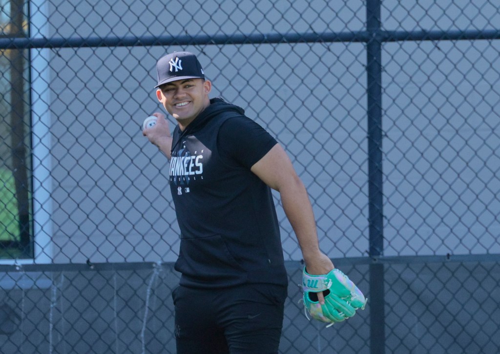 Yankees center fielder Jasson Dominguez, who is coming back from arm surgery, throwing lightly at the New York Yankees Minor League complex in Tampa Florida.