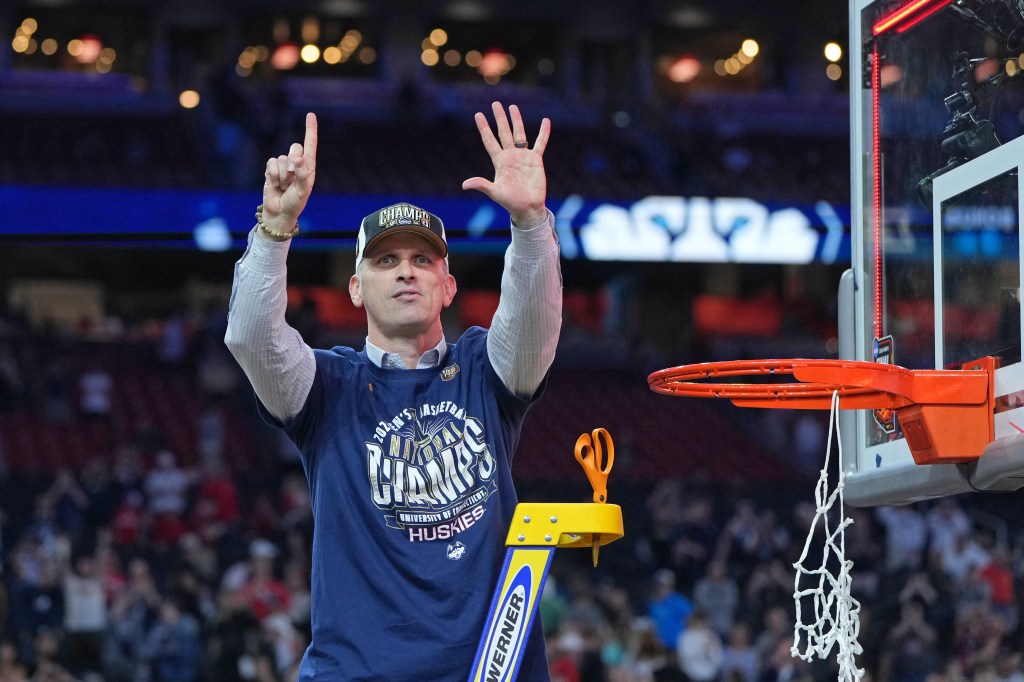 Connecticut Huskies head coach Dan Hurley raising his hands in celebration after winning the 2024 NCAA Tournament National Championship