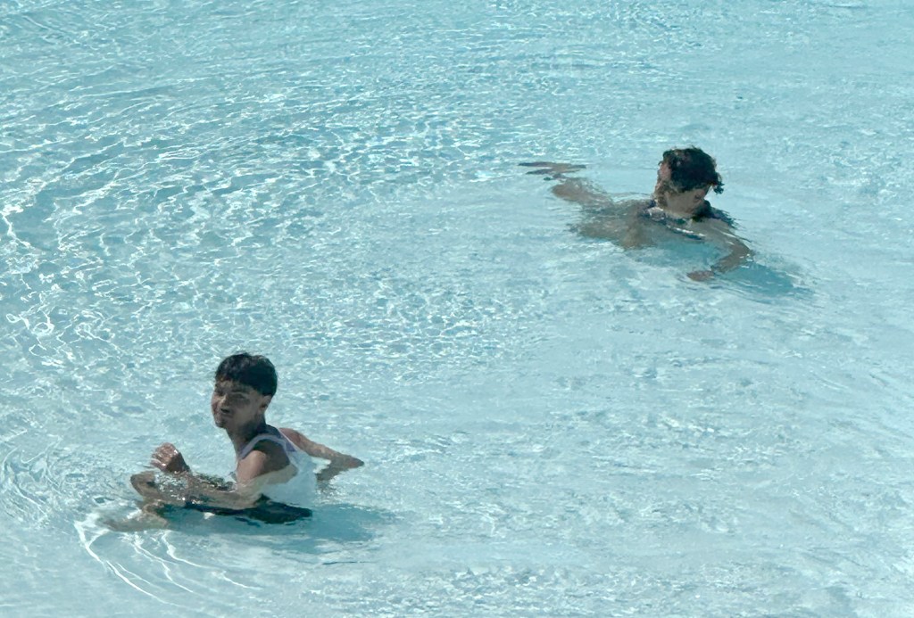 Two unidentified men swimming in the closed Astoria Pool at Astoria Park in Queens, NY