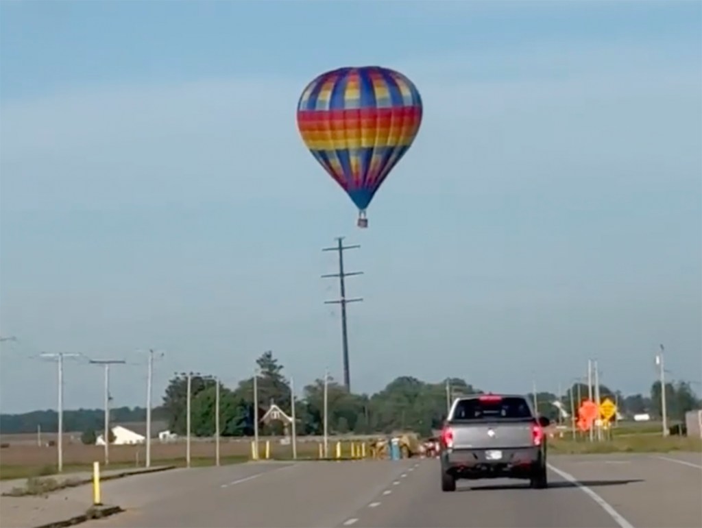 This photo provided by Debbie Wajvoda shows a hot air balloon crashing after hitting a utility pole on Sunday, June 2, 2024 east of Lowell, Ind. 