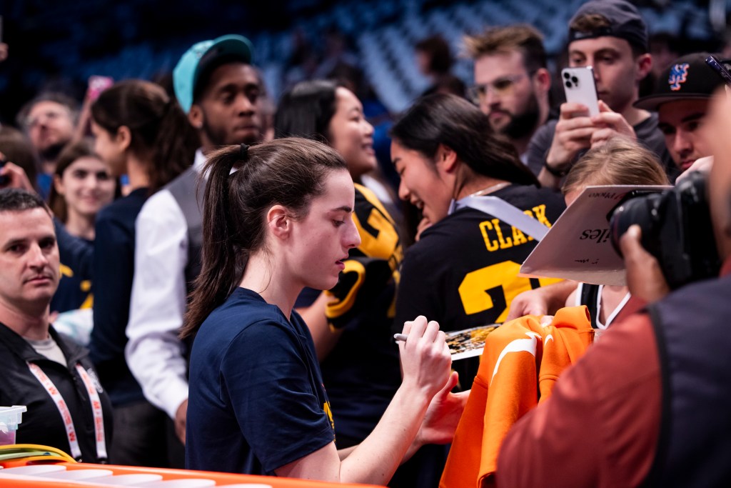 Caitlin Clark signs autographs prior to her game against the New York Liberty.