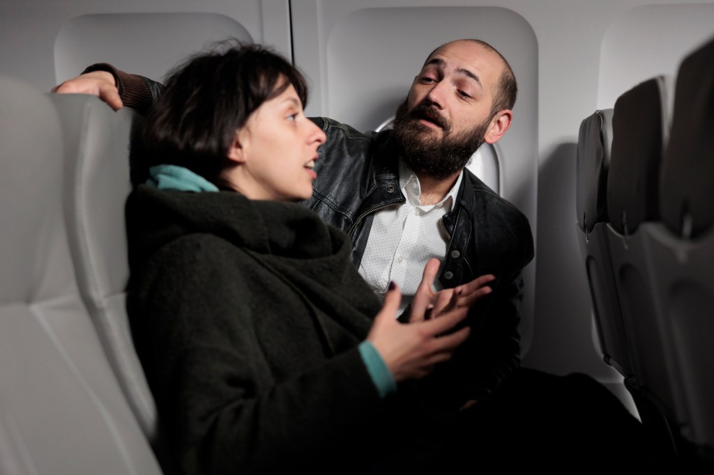 Plane passengers converse on a flight.