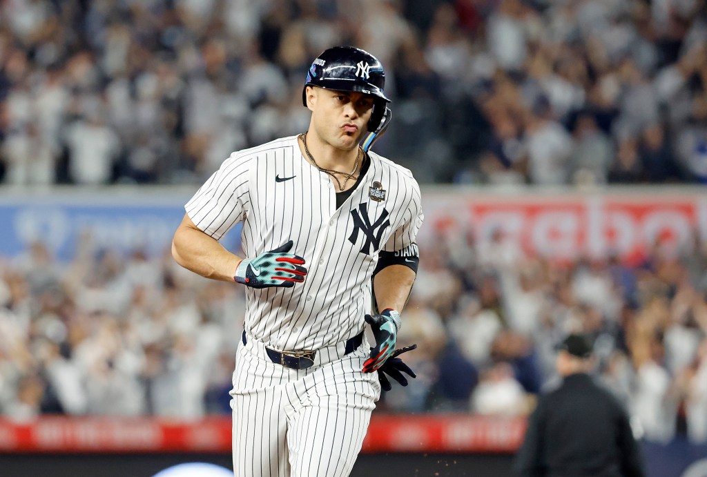 Giancarlo Stanton #27 of the New York Yankees rounds the bases on his solo home run during the third inning of Game 5 on Oct. 30, 2024.
