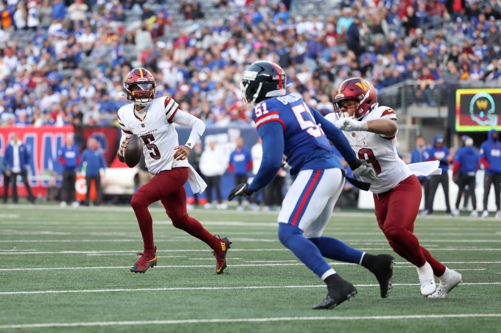 Jayden Daniels runs with the ball during the Commanders' win over the Giants on Nov. 3, 2024. 