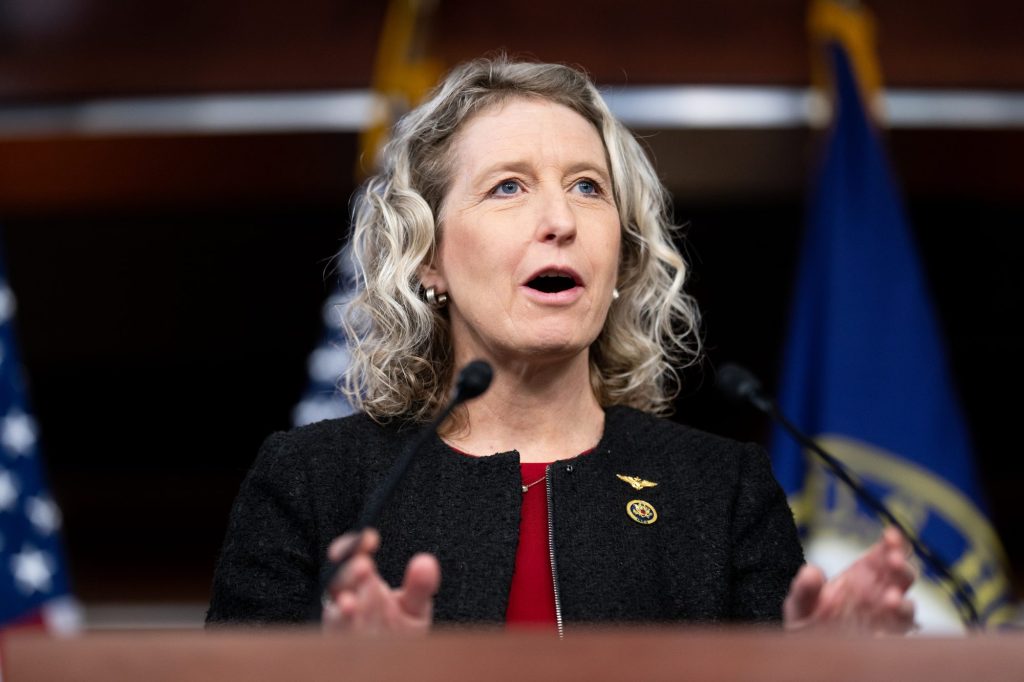 Rep. Jen Kiggans, R-Va., speaking into microphones at the Bipartisan Defending Borders, Defending Democracies Act news conference in the U.S. Capitol.