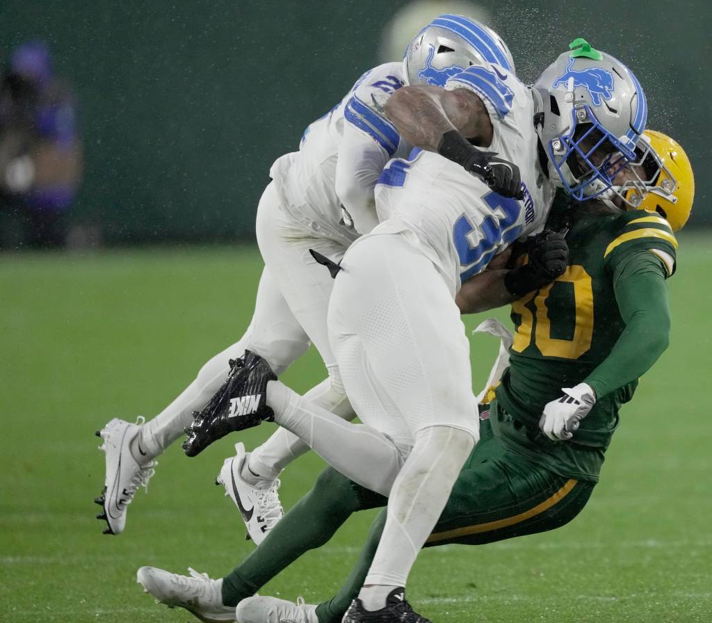  Lions safety Brian Branch (32) hits Green Bay Packers wide receiver Bo Melton (80) during the first quarter of their game Sunday, 